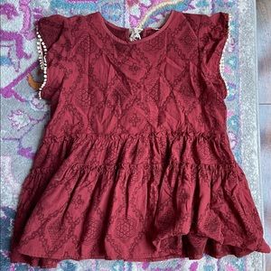 Patterned layered ruffle top with tassel ties in the back.